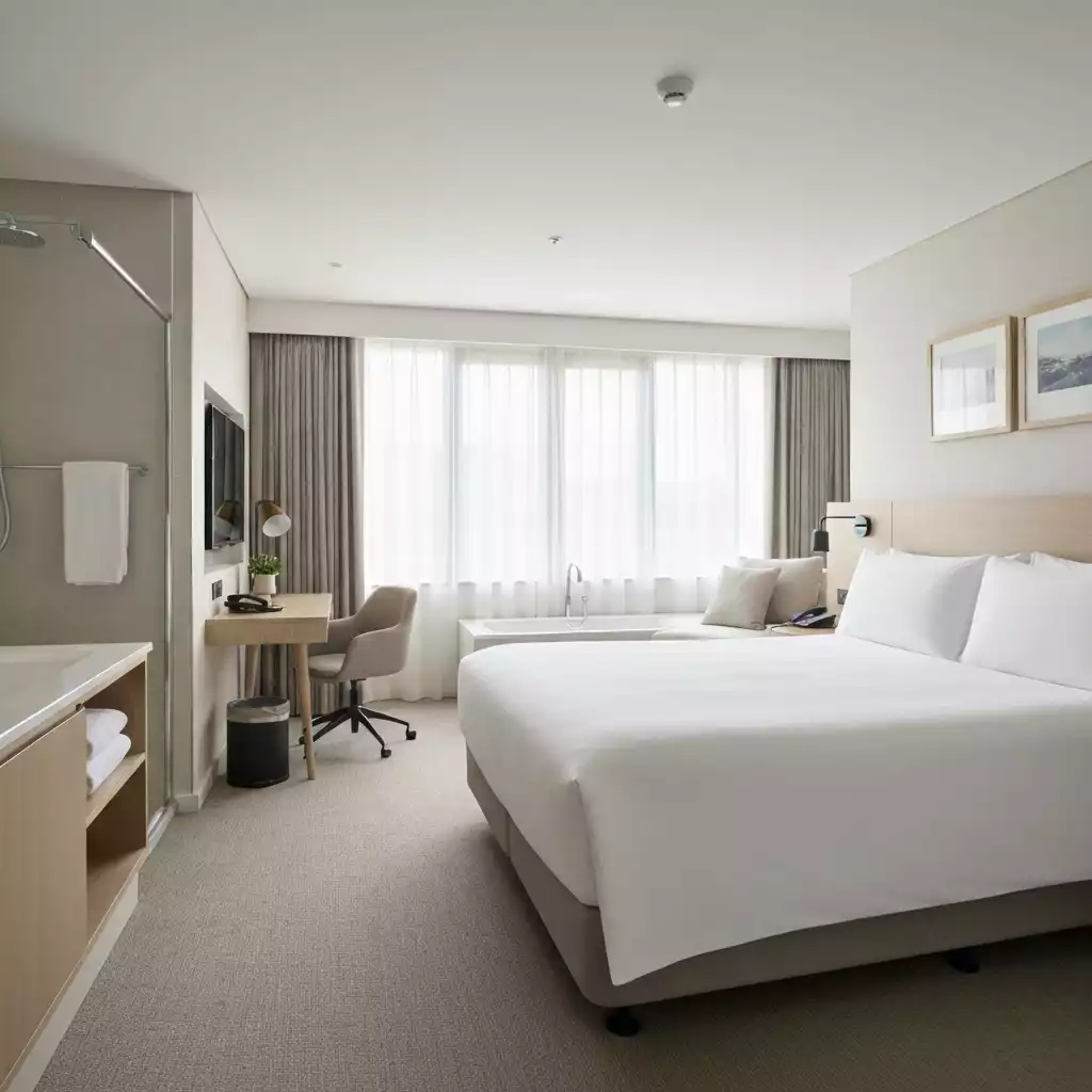 Photograph of a serene hotel room at Avocados Perth, showcasing comfort and modern amenities, no text, no words, no typography, clean image